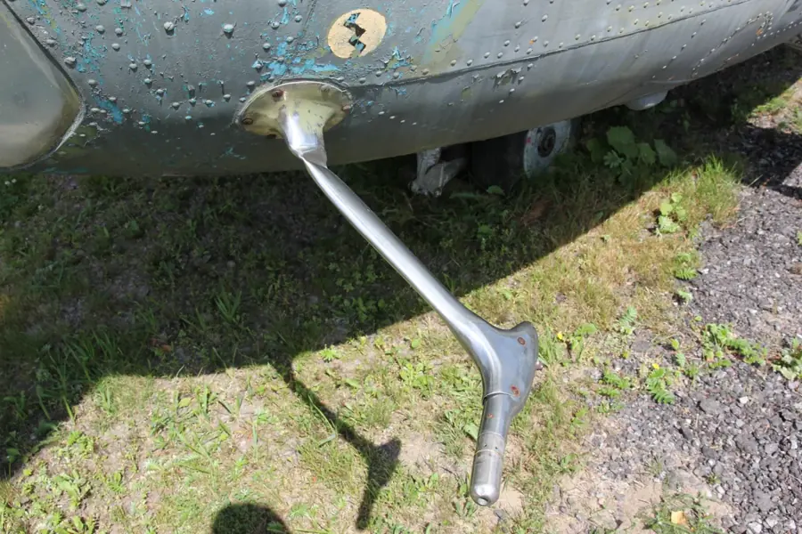 A close-up of a pitot probe, a slim metal tube on a strut projecting from an aircraft nose.